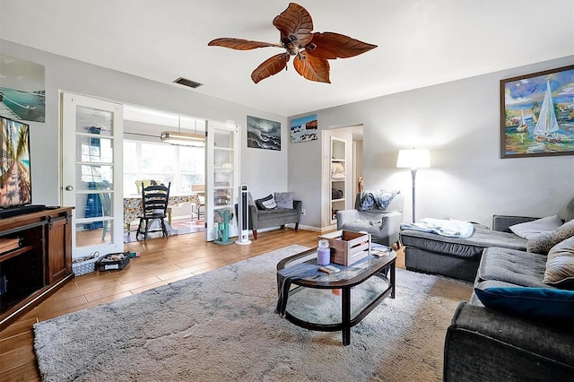 living room featuring light hardwood / wood-style flooring and ceiling fan