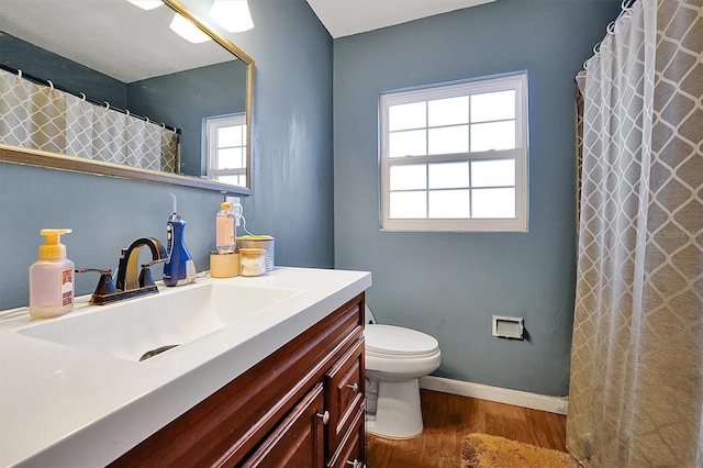 bathroom featuring hardwood / wood-style flooring, vanity, and toilet