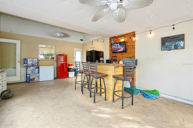 kitchen featuring ceiling fan, black refrigerator, and fridge