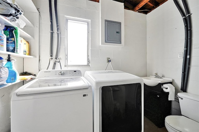 laundry room with a wealth of natural light, sink, electric panel, and washing machine and clothes dryer