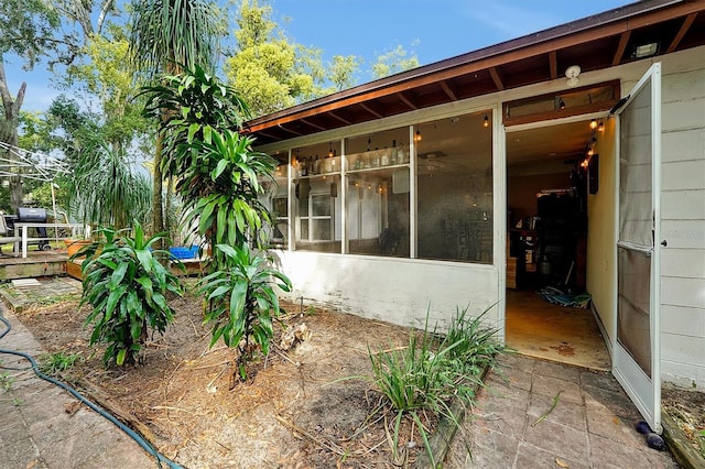 view of side of property with a sunroom