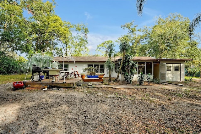 back of property featuring a deck