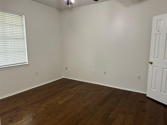 spare room featuring dark hardwood / wood-style floors and ceiling fan