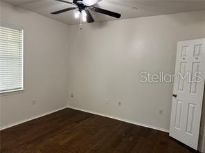 unfurnished room with ceiling fan and dark hardwood / wood-style floors