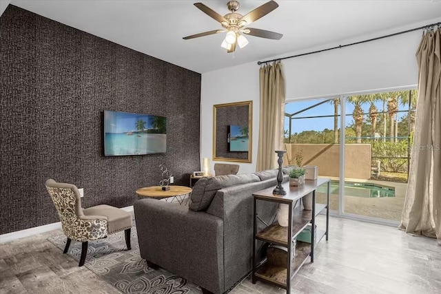 living room with hardwood / wood-style flooring and ceiling fan