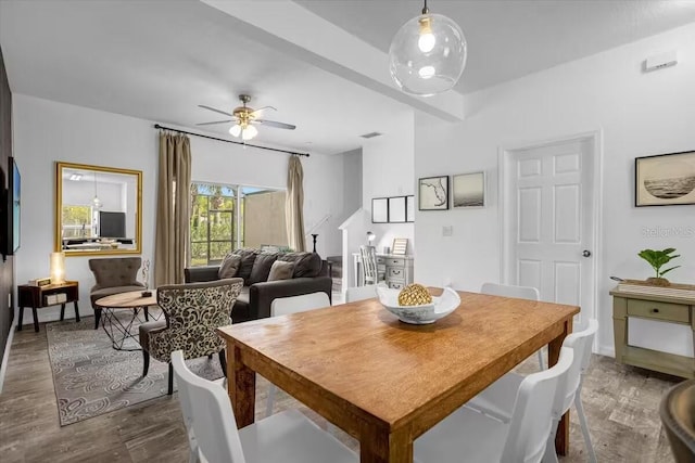 dining room with ceiling fan and dark hardwood / wood-style floors