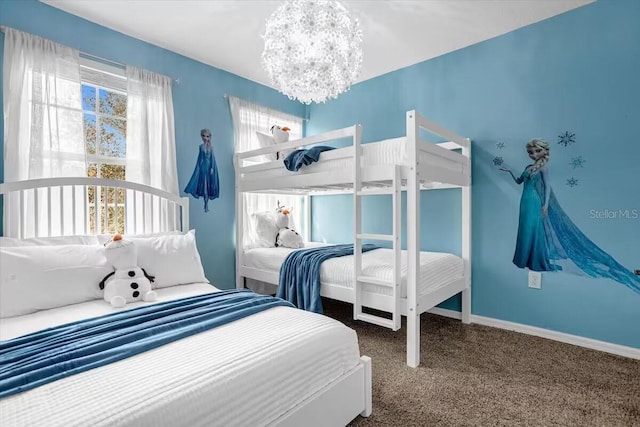 carpeted bedroom featuring an inviting chandelier