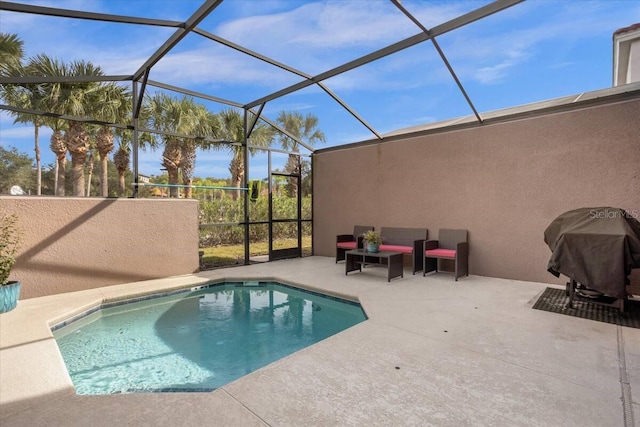 view of swimming pool featuring a lanai, a patio, and grilling area