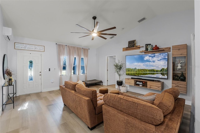 living room with a wall mounted air conditioner, light wood-type flooring, ceiling fan, and lofted ceiling