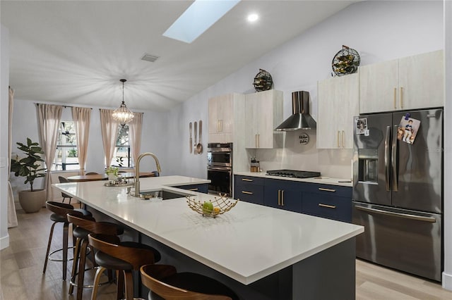 kitchen with sink, stainless steel refrigerator with ice dispenser, pendant lighting, a breakfast bar, and a center island with sink