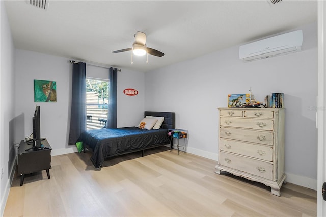 1681 E Evelyn St, Hernando, FL 34442 - bedroom featuring a wall unit AC, light wood-style floors, and a ceiling fan