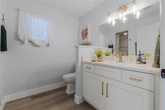 bathroom featuring wood-type flooring, vanity, toilet, and a shower with curtain