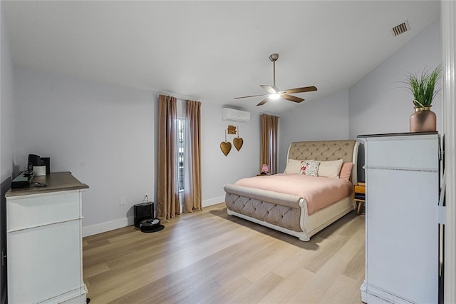 bedroom featuring a wall mounted air conditioner, light wood-type flooring, ceiling fan, and lofted ceiling