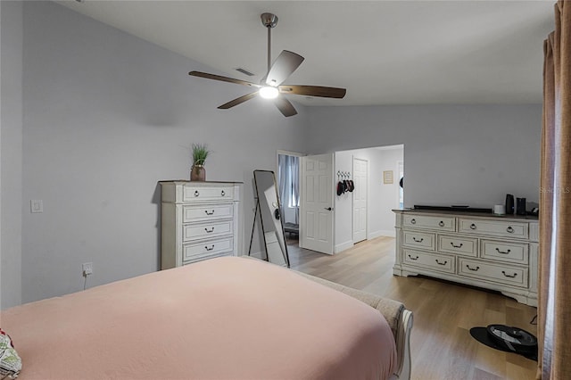 bedroom featuring ceiling fan, vaulted ceiling, and light wood-type flooring