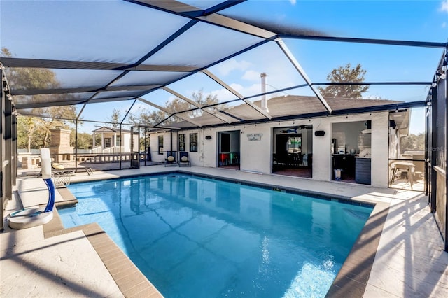 view of pool with a patio, ceiling fan, and a lanai