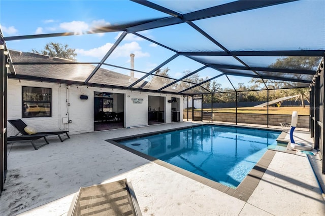 view of pool with a lanai, ceiling fan, and a patio