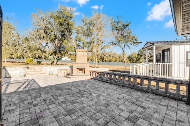 view of patio / terrace featuring an outdoor fireplace