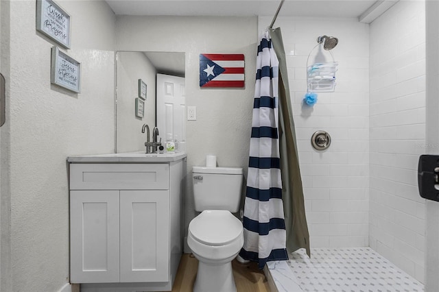 bathroom featuring curtained shower, vanity, and toilet