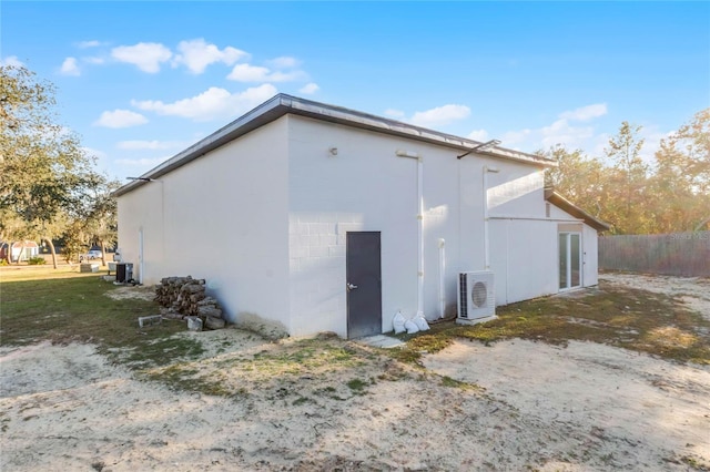 view of side of property featuring ac unit and central air condition unit