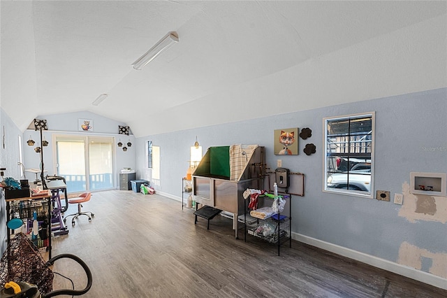 misc room with dark wood-type flooring and vaulted ceiling