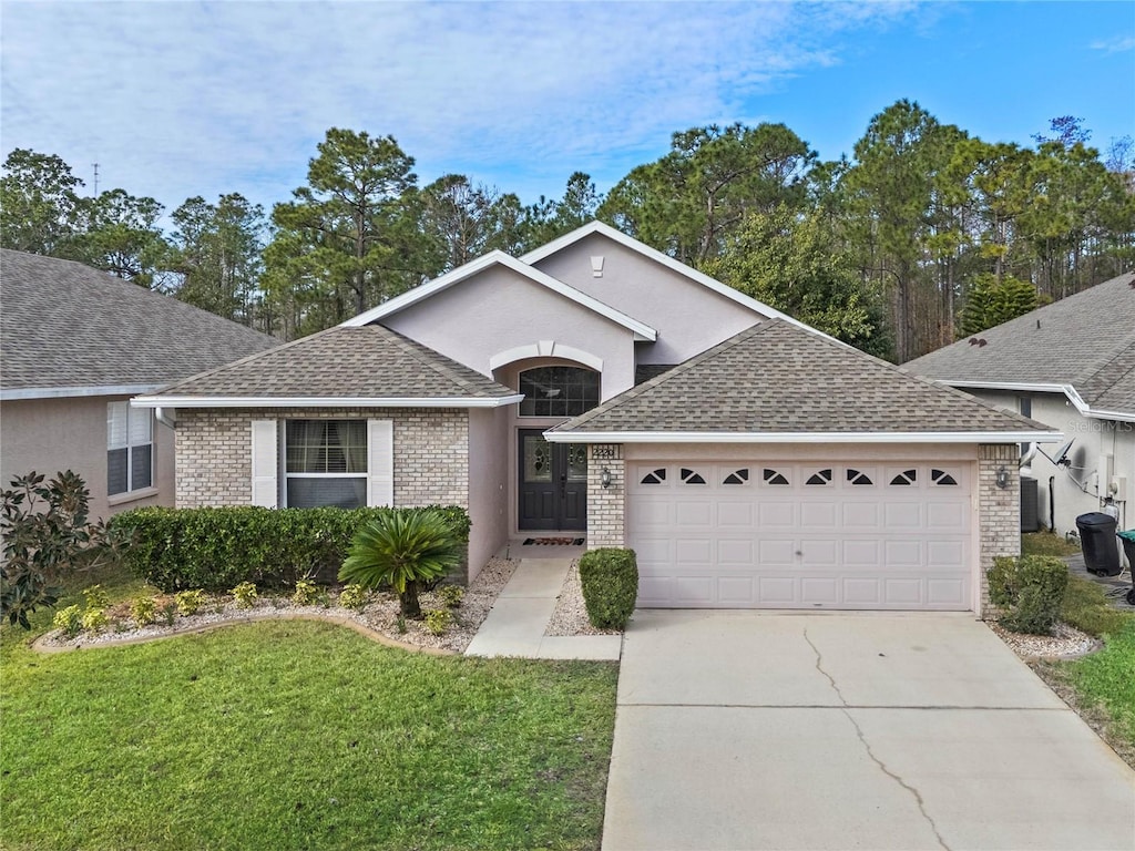 ranch-style house with a front lawn, central AC unit, and a garage