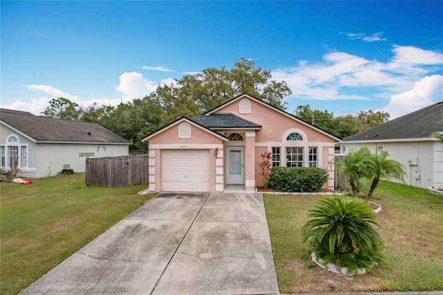 view of front of property with a garage and a front lawn