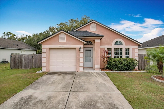 view of front of home with a garage and a front yard