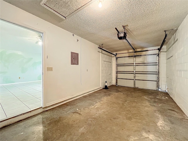 garage with a garage door opener and electric panel