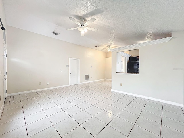 tiled empty room featuring a textured ceiling and ceiling fan