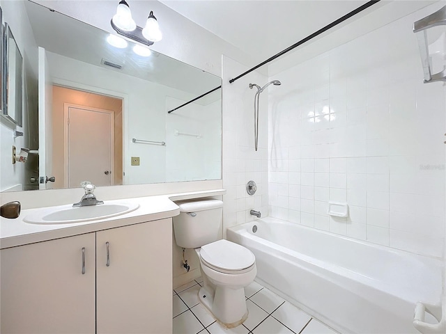 full bathroom with vanity, tiled shower / bath combo, tile patterned floors, and toilet