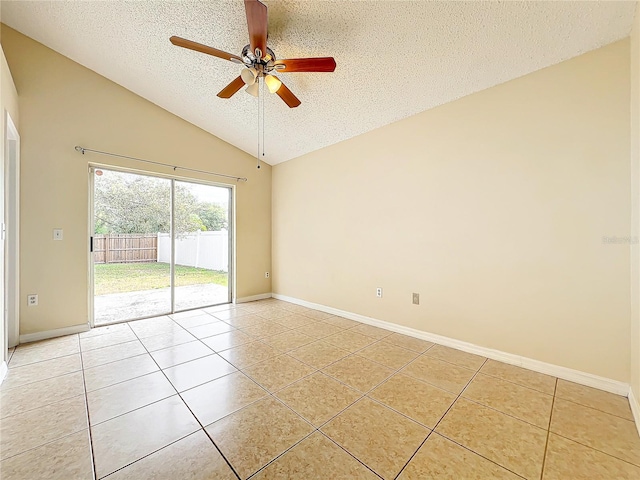 empty room featuring vaulted ceiling, light tile patterned floors, ceiling fan, and a textured ceiling