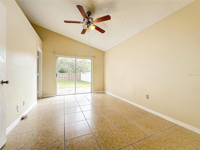 spare room with ceiling fan, vaulted ceiling, a textured ceiling, and light tile patterned floors