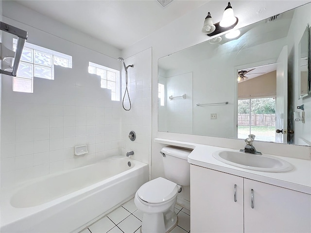 full bathroom featuring vanity, tiled shower / bath combo, plenty of natural light, and toilet