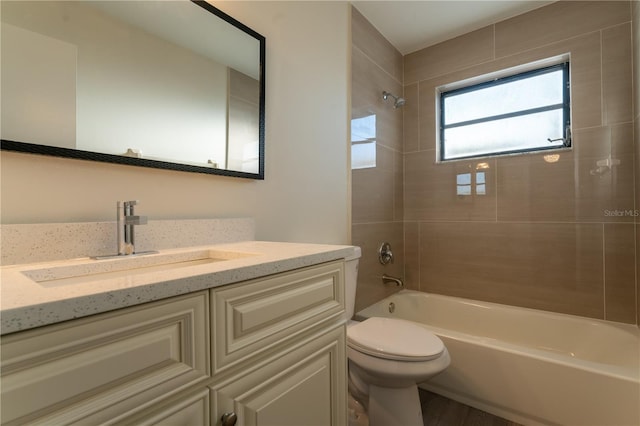 full bathroom featuring vanity, toilet, wood-type flooring, and tiled shower / bath