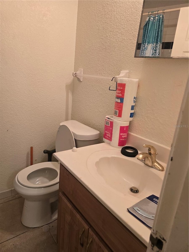 bathroom with a shower with shower curtain, vanity, toilet, and tile patterned flooring