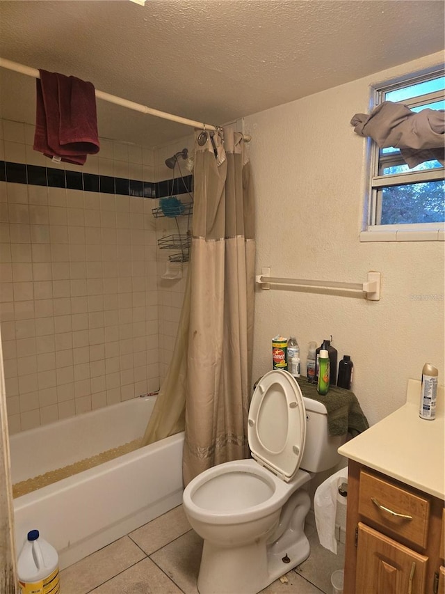 full bathroom featuring tile patterned floors, a textured ceiling, toilet, shower / bath combo with shower curtain, and vanity