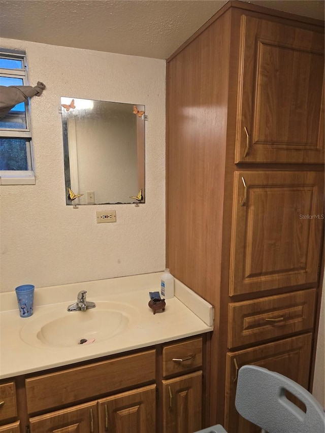 bathroom with vanity and a textured ceiling