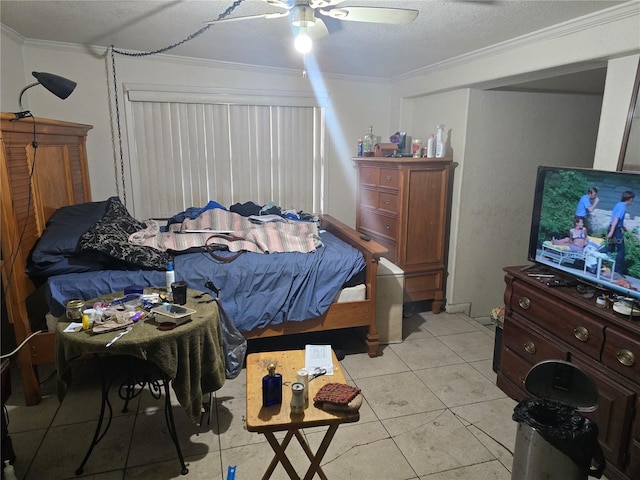 tiled bedroom featuring ceiling fan, a textured ceiling, and ornamental molding