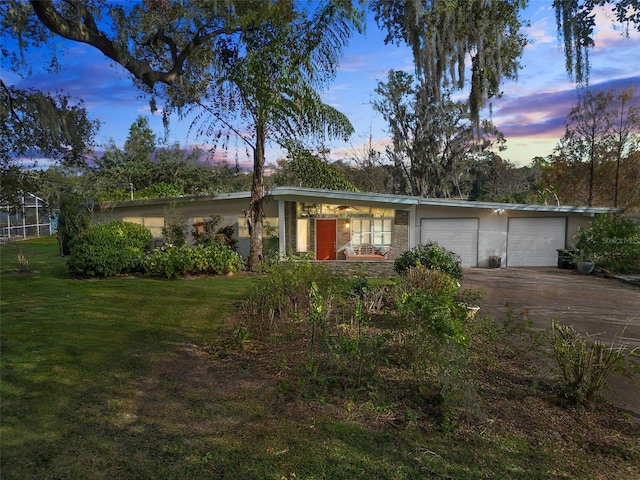 ranch-style house with a lawn and a garage