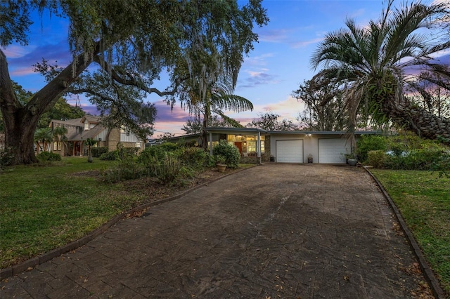 view of front of house featuring a lawn and a garage