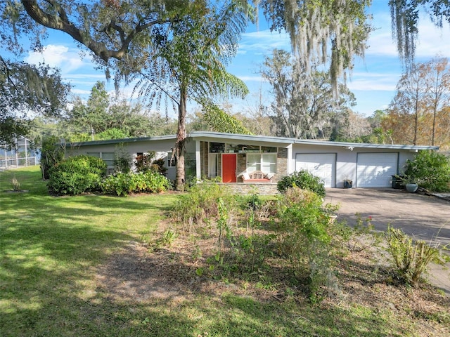 ranch-style home featuring a garage and a front lawn