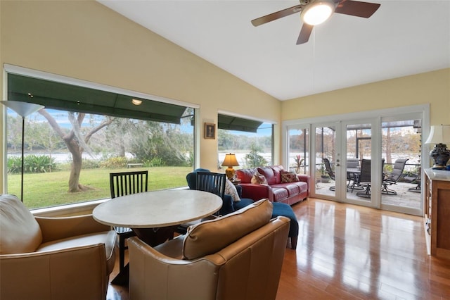 sunroom / solarium featuring ceiling fan, vaulted ceiling, and french doors