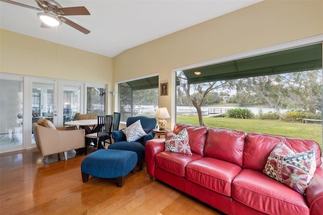 sunroom with ceiling fan, vaulted ceiling, a wealth of natural light, and french doors