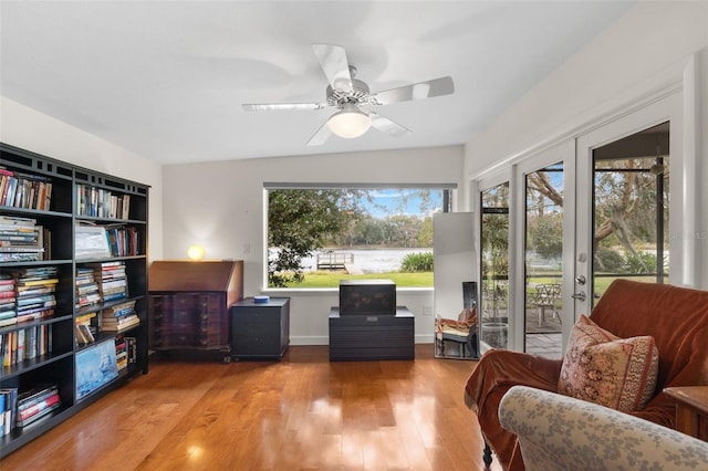 living area with ceiling fan, light hardwood / wood-style flooring, a wealth of natural light, and french doors