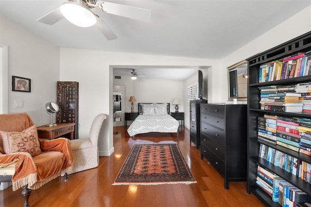 bedroom with ceiling fan and dark hardwood / wood-style floors