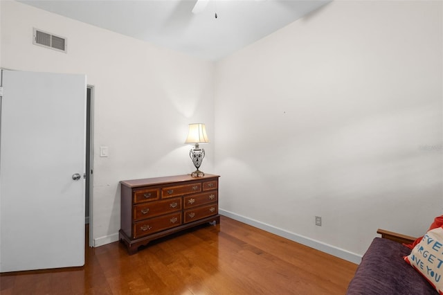 living area with ceiling fan and wood-type flooring