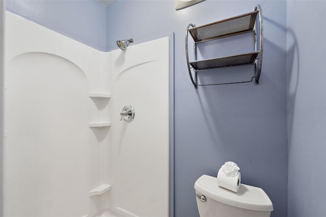 bathroom featuring toilet and walk in shower