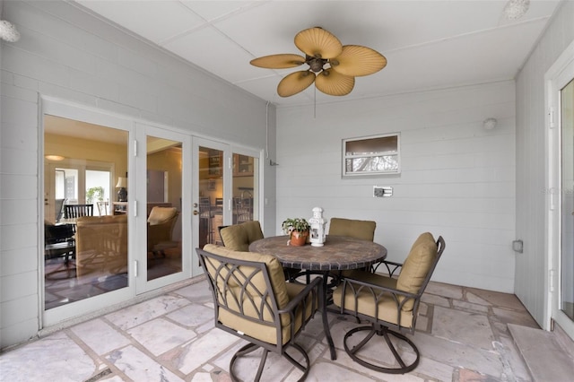 sunroom / solarium featuring french doors and ceiling fan