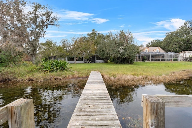 dock area featuring a yard and a water view