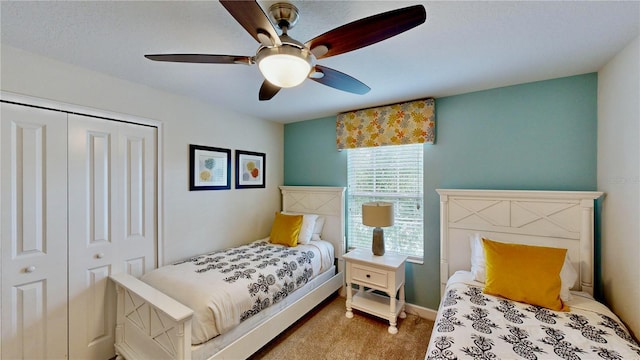 bedroom with carpet, ceiling fan, and a closet